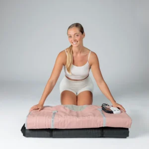 Infrared Sauna blanket main product picture with model sitting behind the best rated beauty device with many good benefits