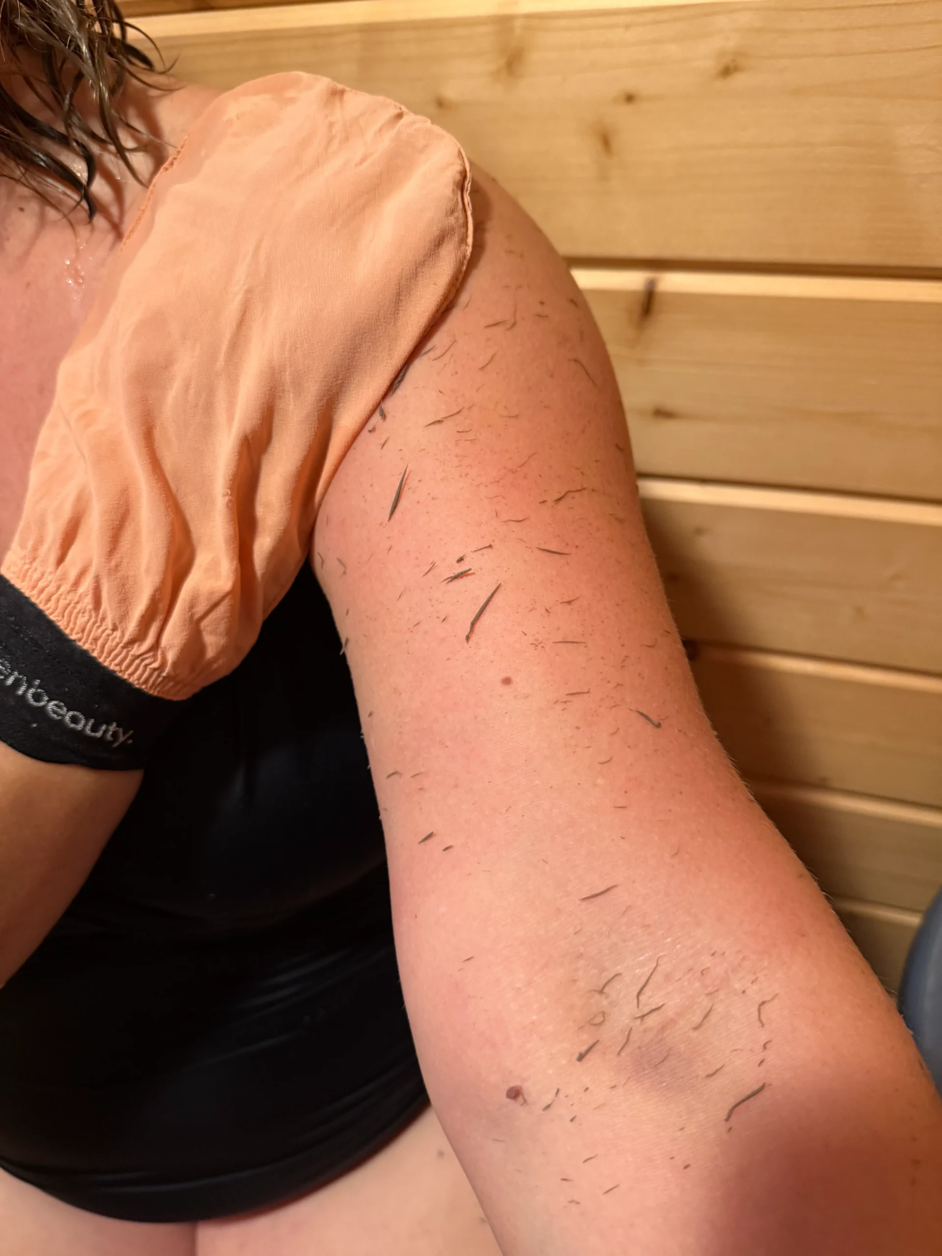 Woman enjoying a self-care routine, showing off radiant and glowing skin after using an exfoliating exfoliant