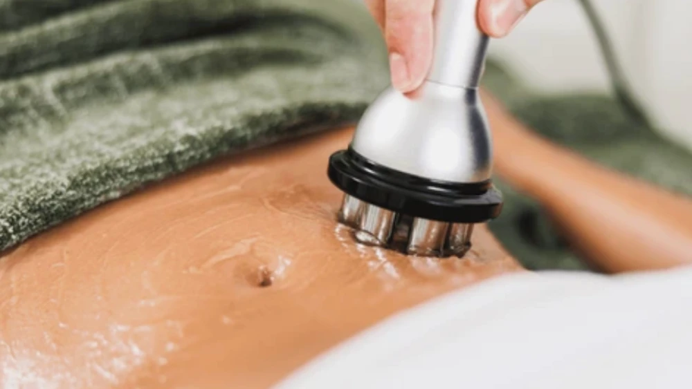 Cavitation machine in use on belly with ultrasound gel