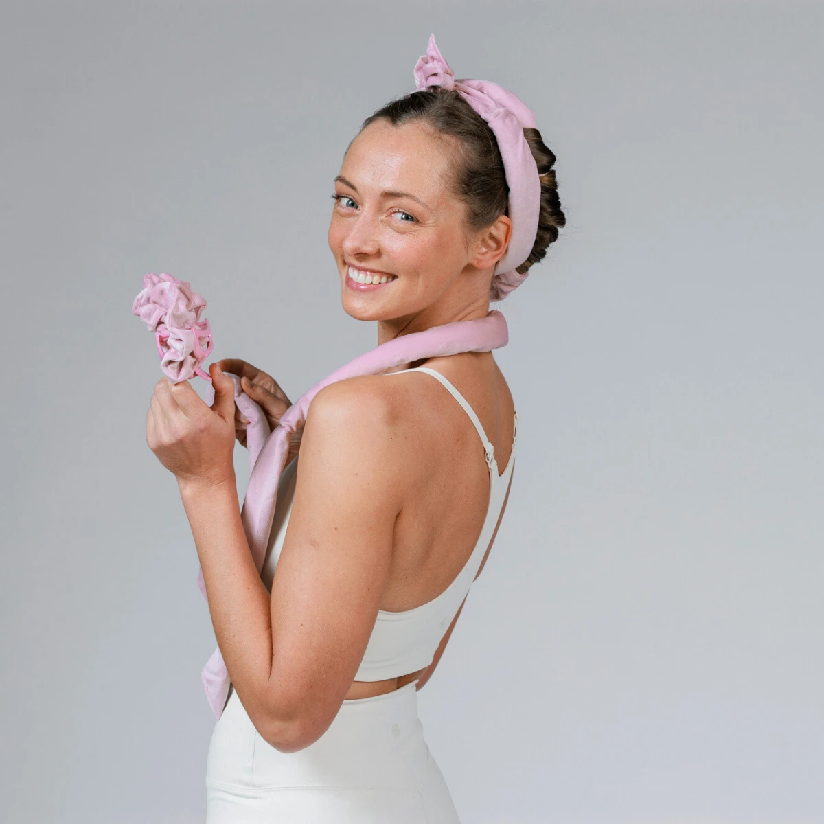 Heatless Hair Curler on head, with model holding the set